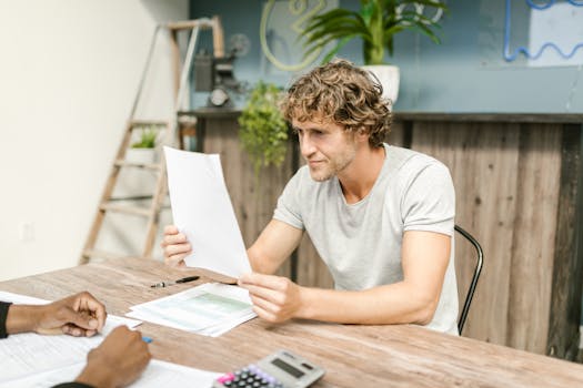 A person reviewing mortgage documents at a desk