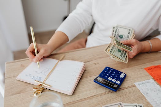 image of a person reviewing their budget with a calculator