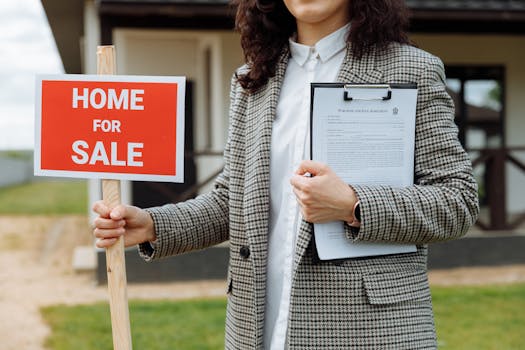 house with a “For Sale” sign