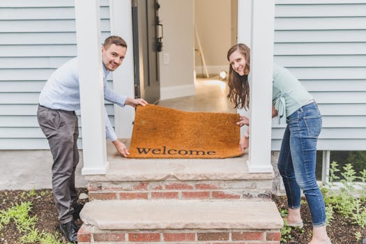 A happy family in front of their new home