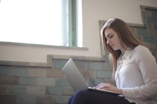 person using a laptop to research mortgage options