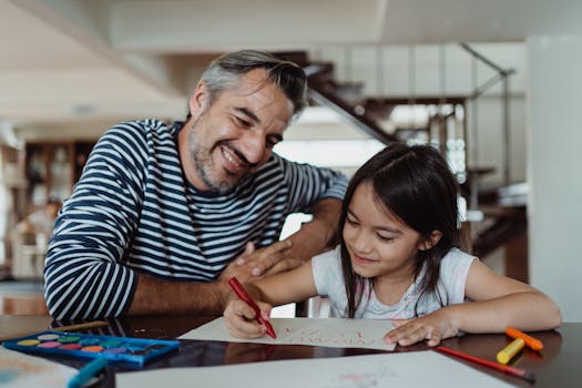 family looking over home plans at a table