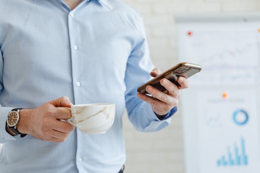 person using smartphone to check financial news